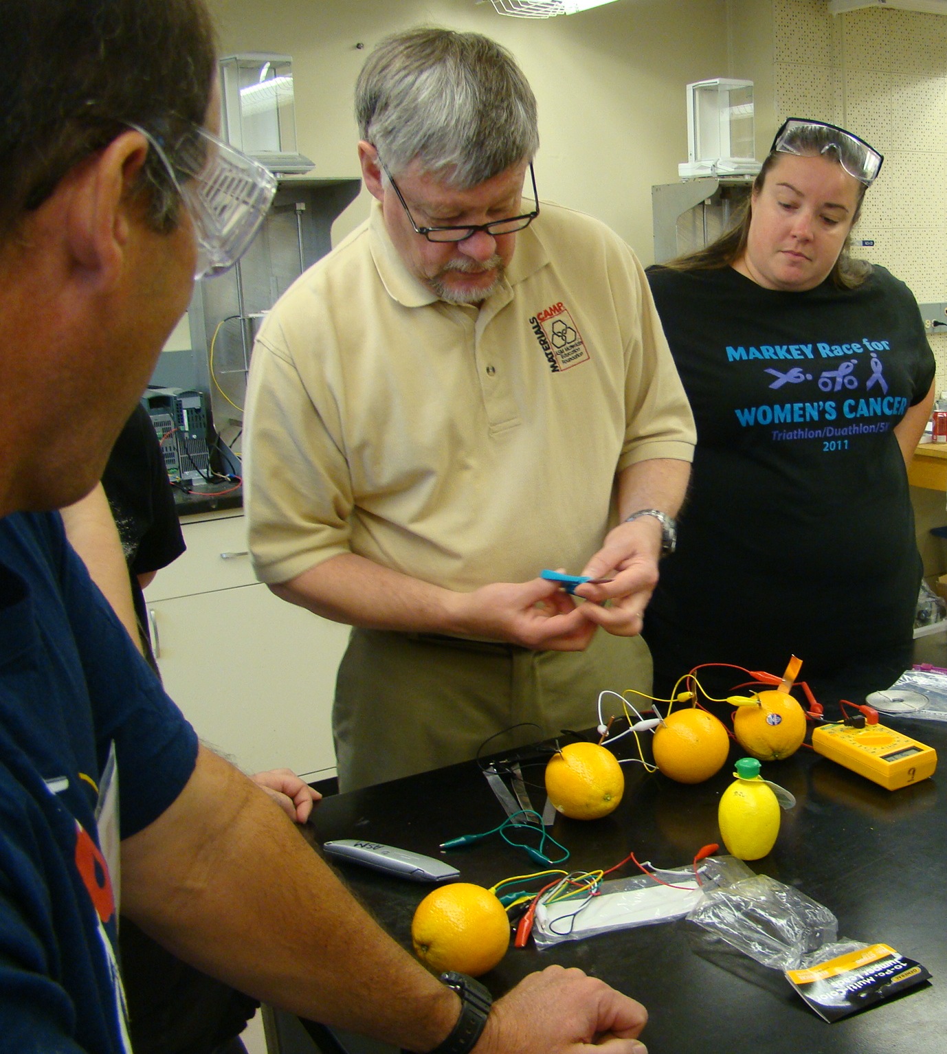 Master teacher Nydam demostrates lemon battery experiment