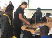 Graduate student Sarah Wolf demonstrates optical cloaking to Philadelphia high-school students at an event organized by the National Society of Black Engineers.